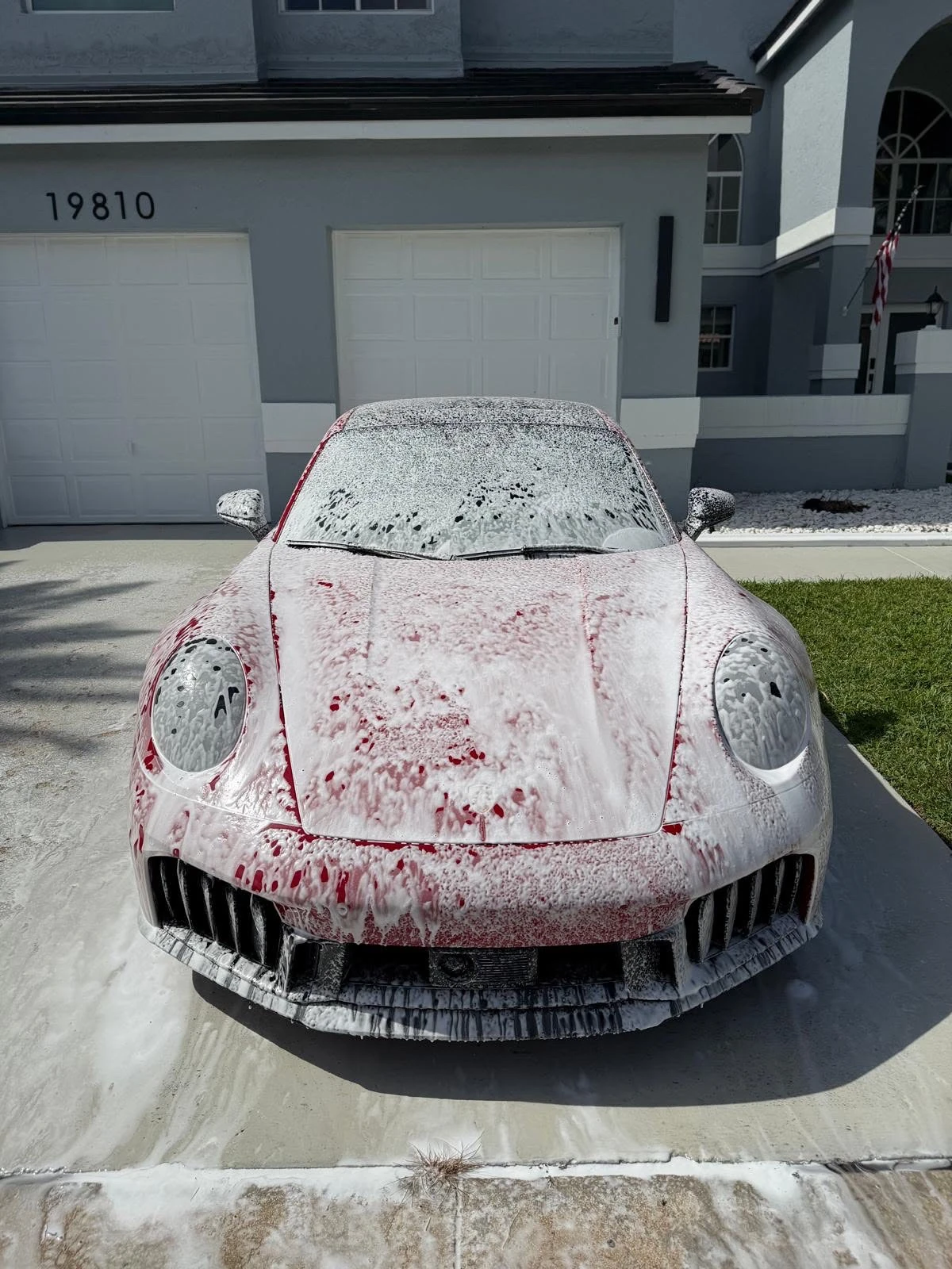 Red Porsche during an authentic DeliciousLab foam wash